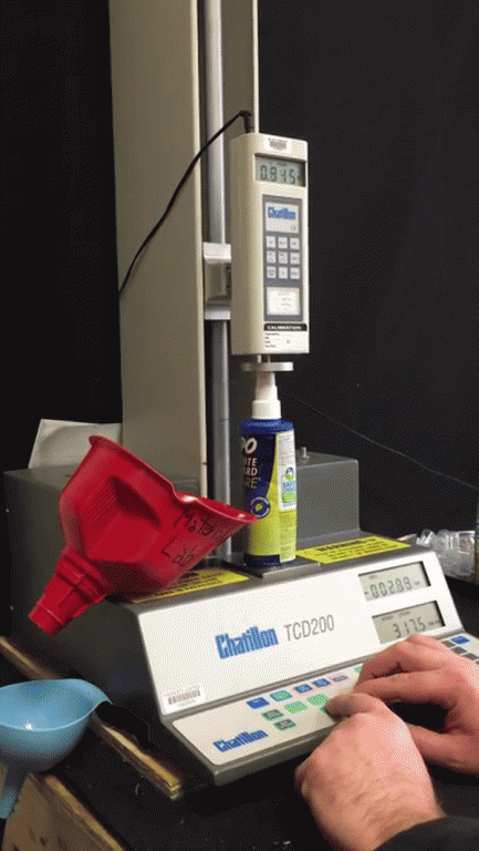 Image of a spray pump bottle undergoing an actuator test.