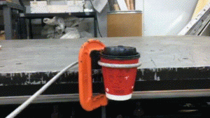 Animated image of a coffee cup lid removal force test.